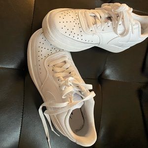 Low top white sneakers.